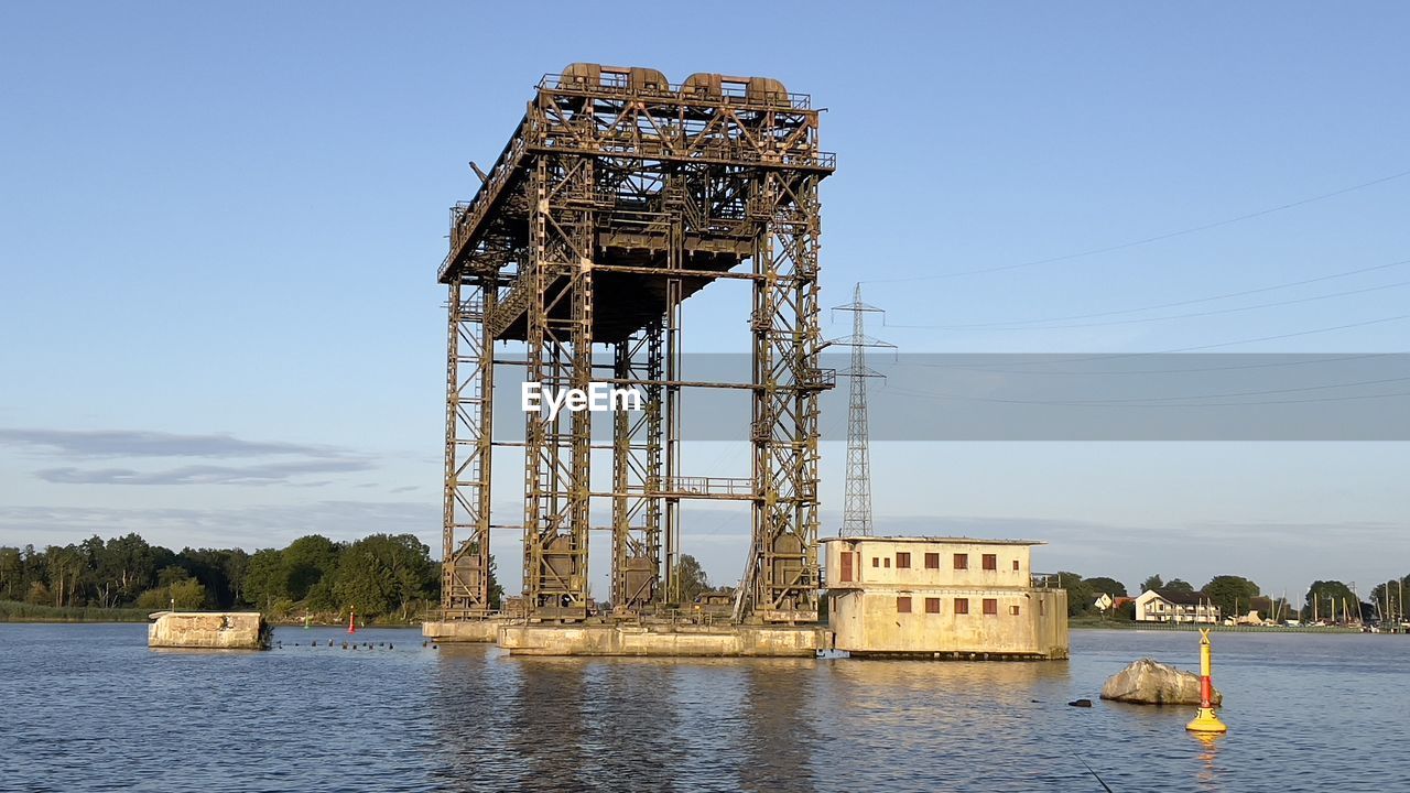 water, architecture, sky, built structure, tower, nature, industry, vehicle, day, no people, transportation, outdoors, blue, building exterior, lake, power generation, landmark, travel destinations