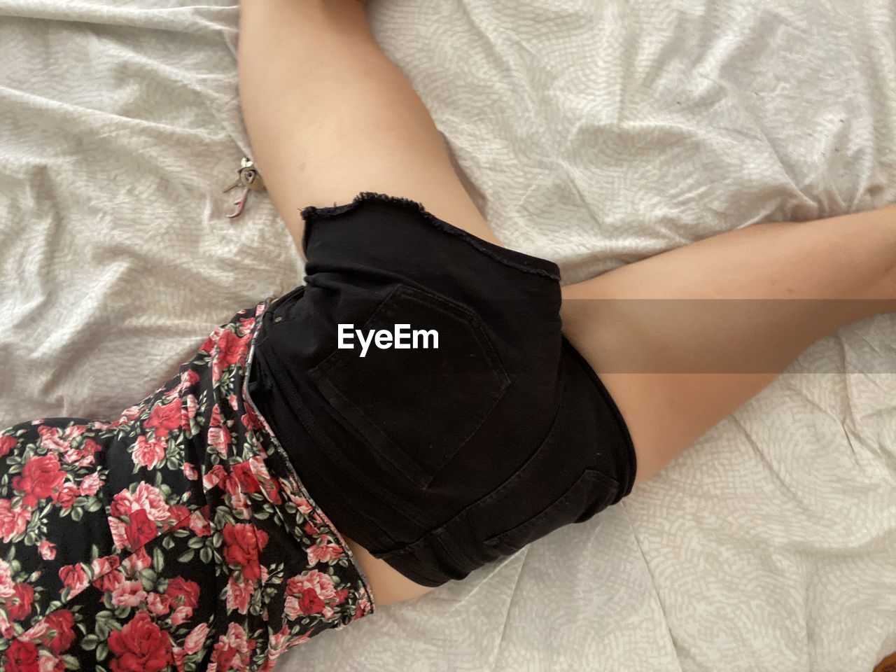 Midsection of woman lying on bed