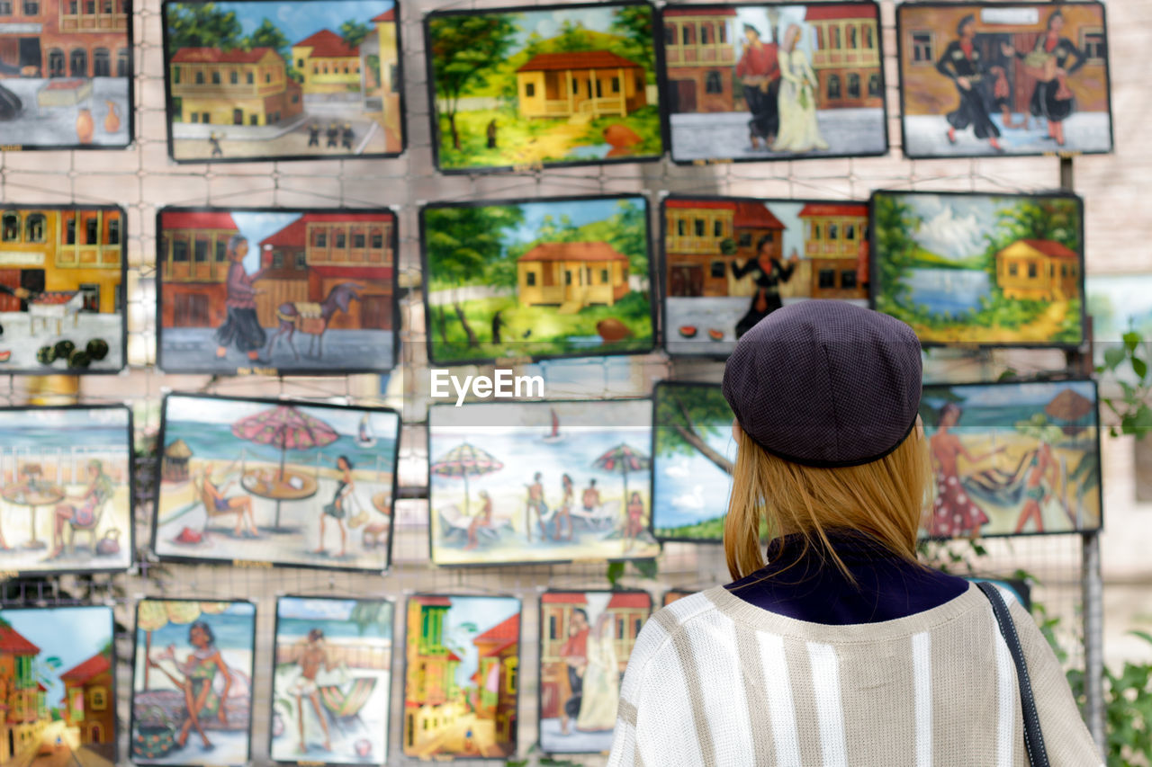 Rear view of a woman by market stall