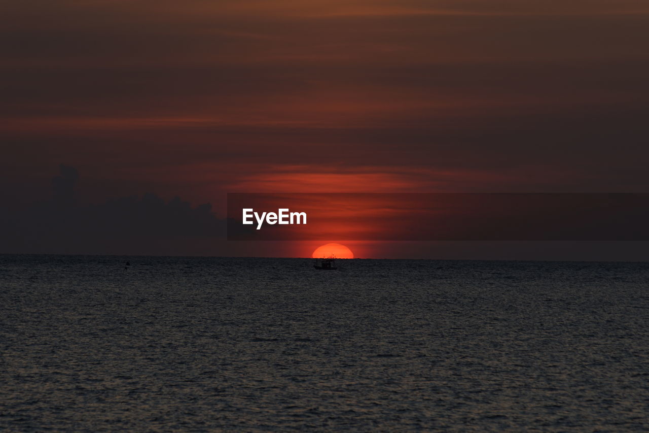 Scenic view of sea against romantic sky at sunset