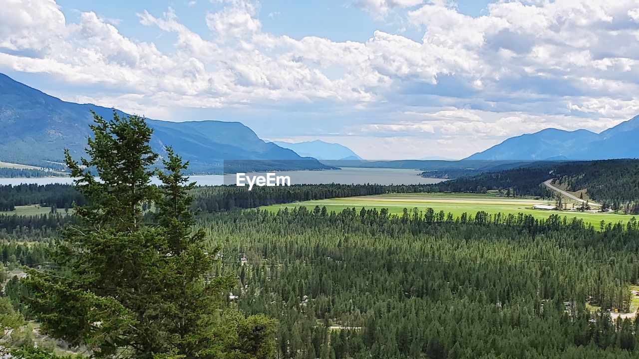 SCENIC VIEW OF FARMS AGAINST SKY