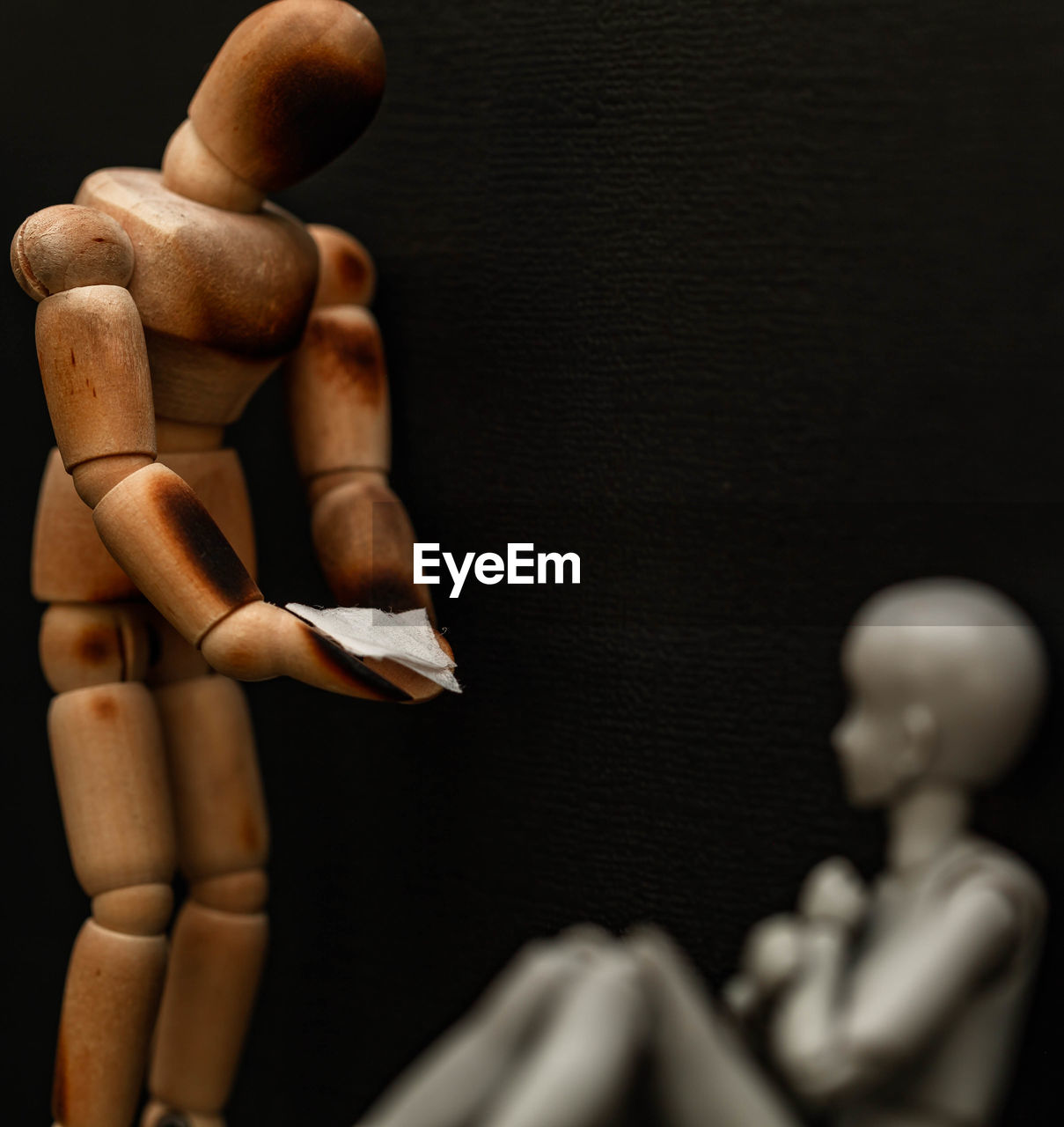 Close-up of wooden figurines against black background