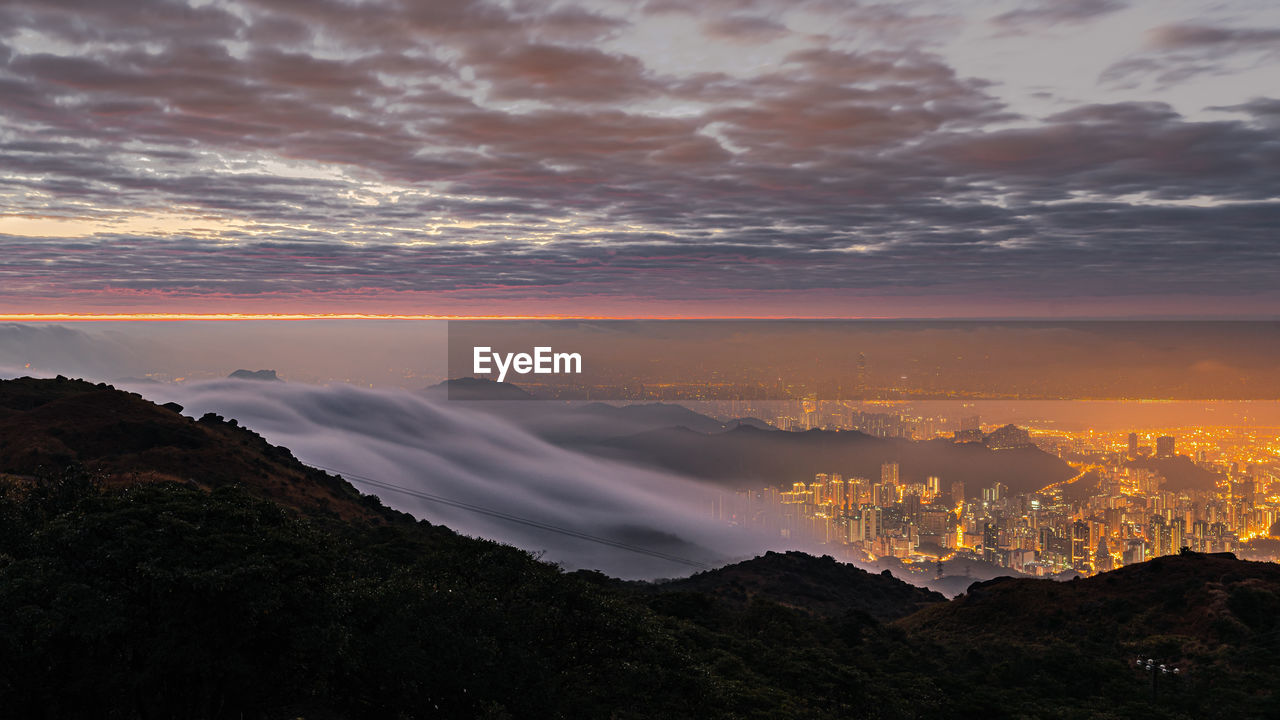 Sea of clouds over hong kong city at dawn, scenic view of dramatic sky at mountain top, tai mo shan