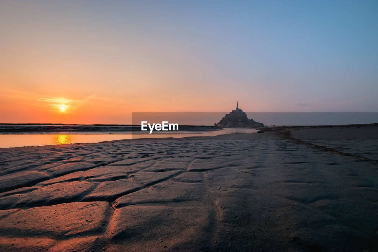 View of mont saint-michel and river against sky during sunset