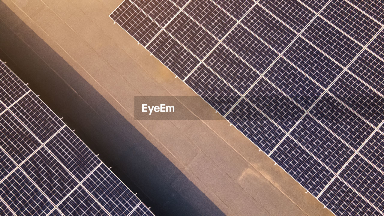 Aerial view of solar panels on top of a building, eco building, or factory. 