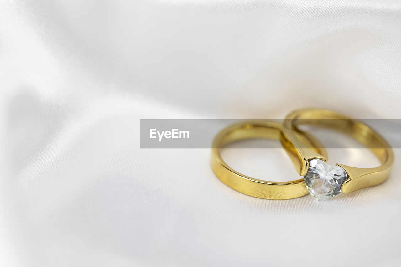 ring, wedding, wedding ring, jewelry, love, event, celebration, life events, married, fashion accessory, gold, positive emotion, engagement ring, emotion, newlywed, diamond, togetherness, romance, dedication, diamond ring, bride, engagement, wedding ceremony, jewellery, bonding, yellow, ceremony, two objects, copy space, white, wedding ceremony supply, wealth, metal, luxury, close-up, silver, adult, unity, women, indoors, shiny, platinum