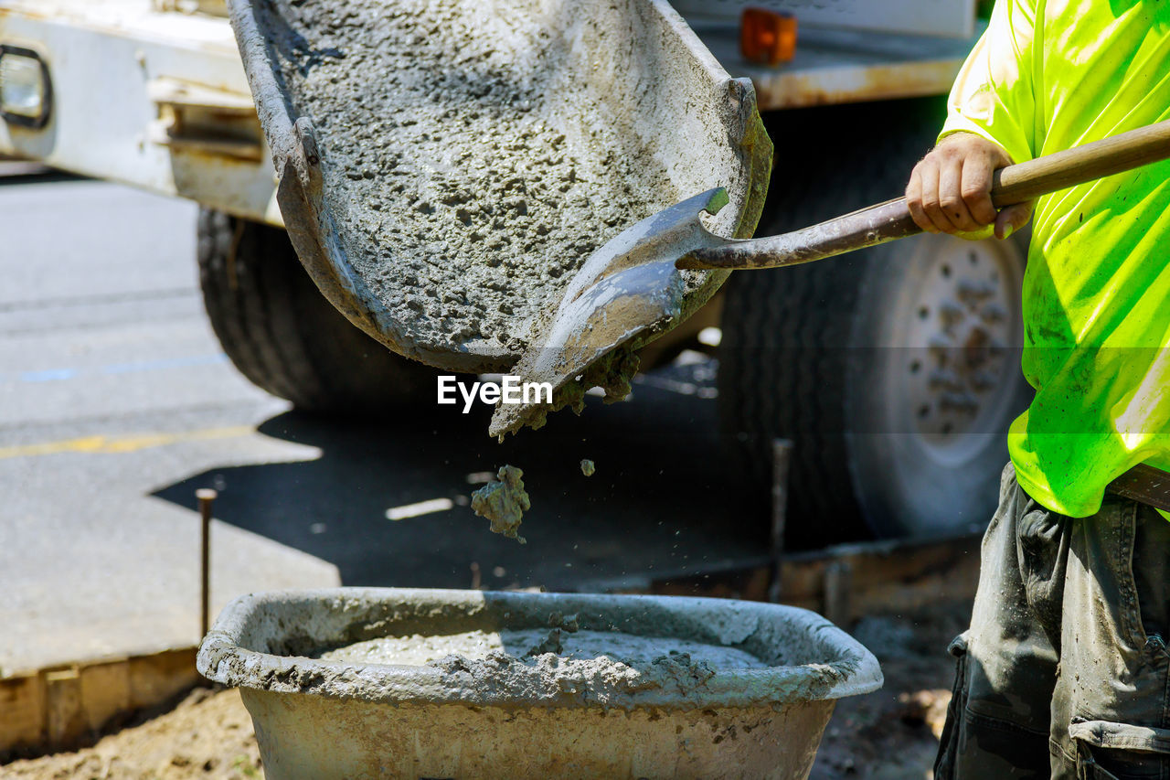 MAN WORKING IN WATER AT CAMERA