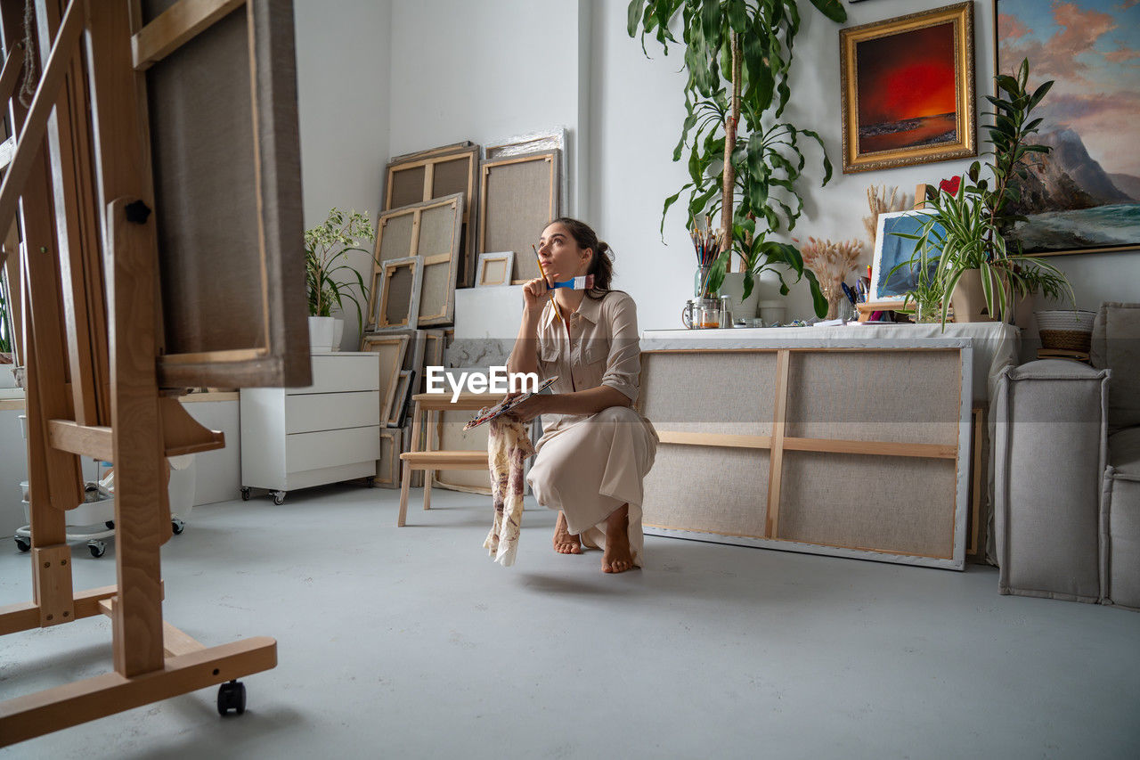 side view of young woman sitting on staircase