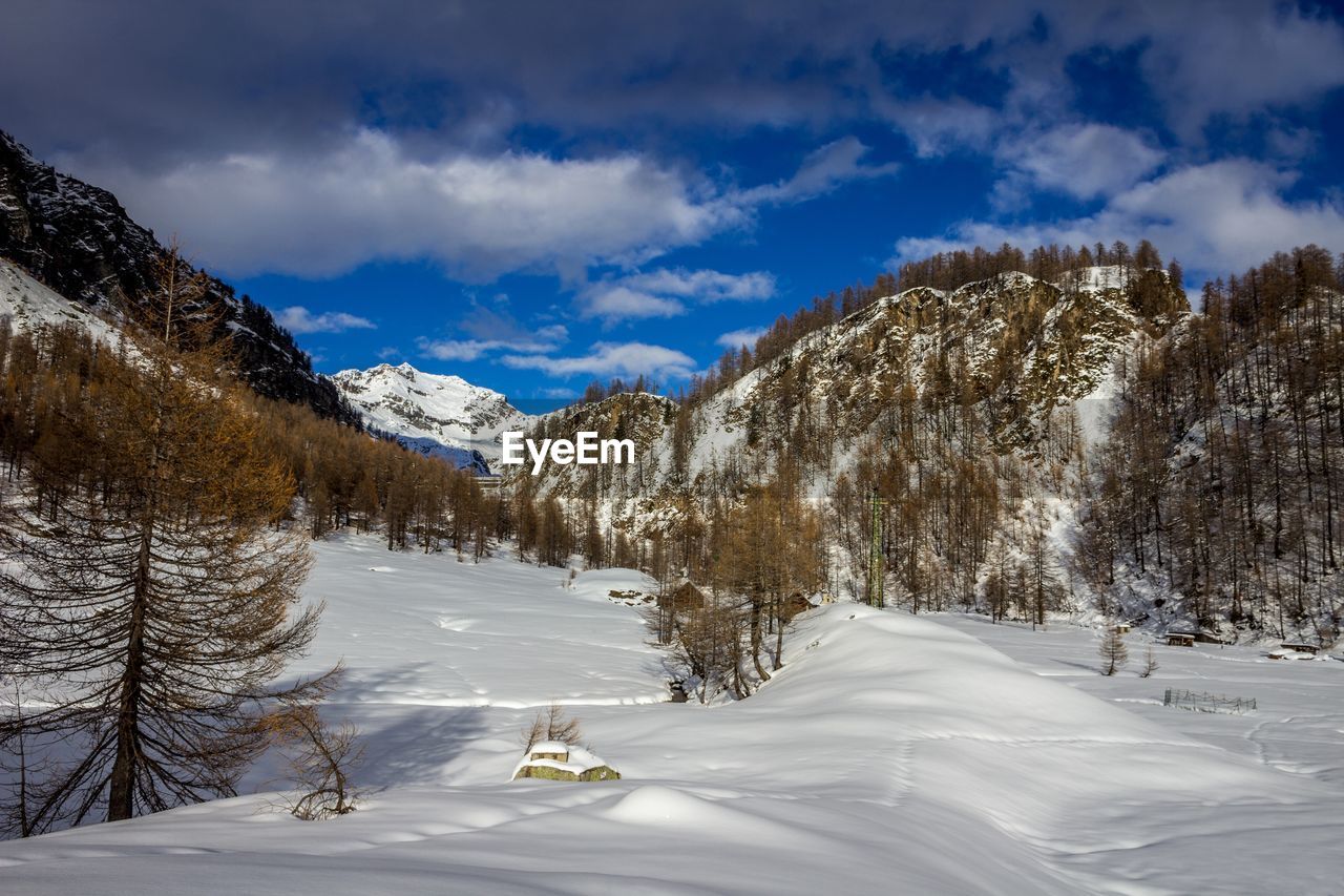 Scenic view of snow covered mountains against sky