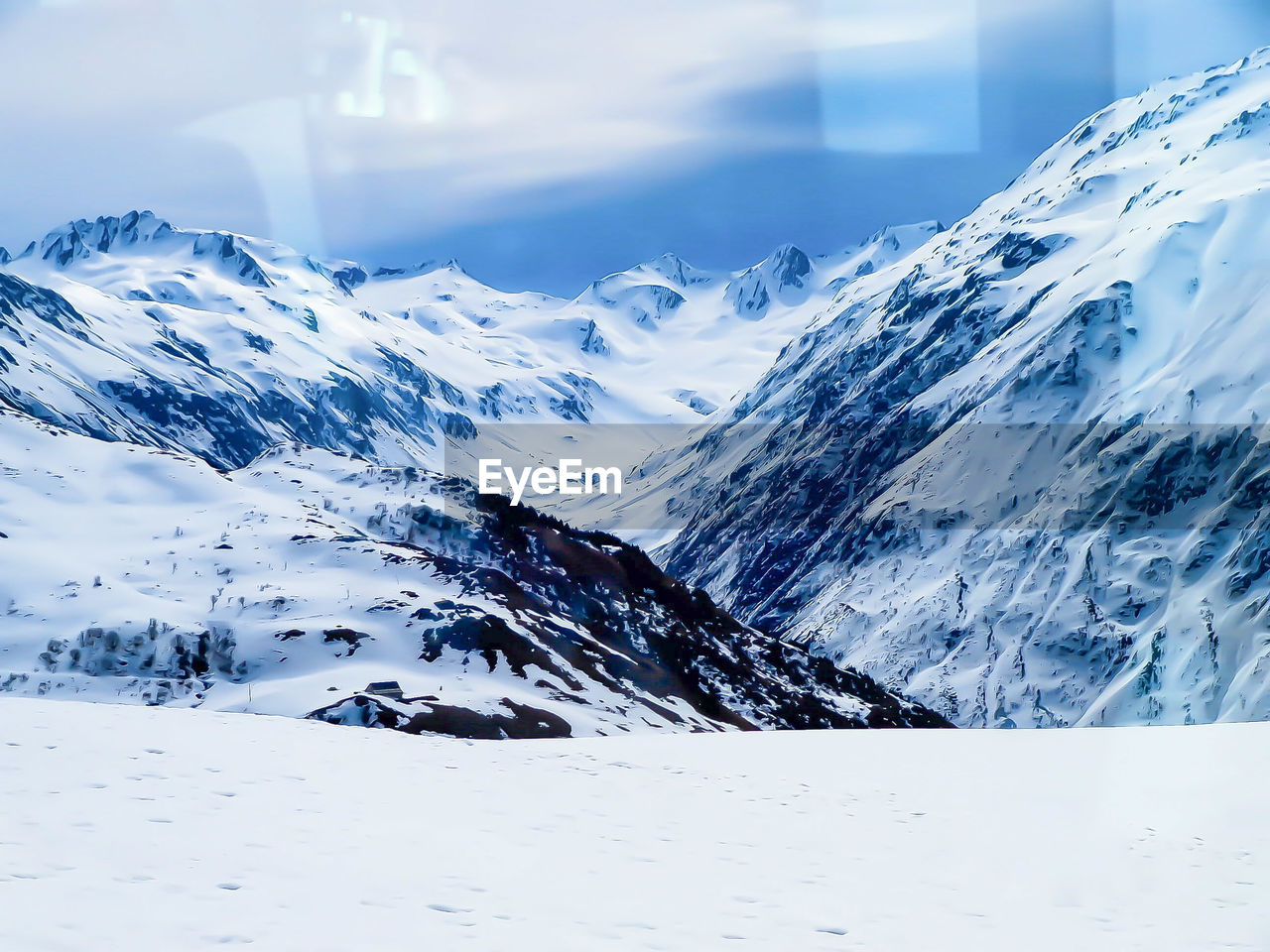 Snow covered landscape against the sky