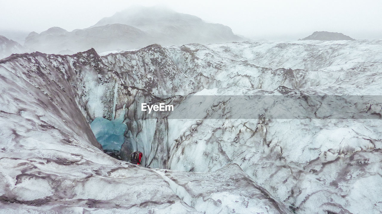 Scenic view of glacier landscape against sky during winter