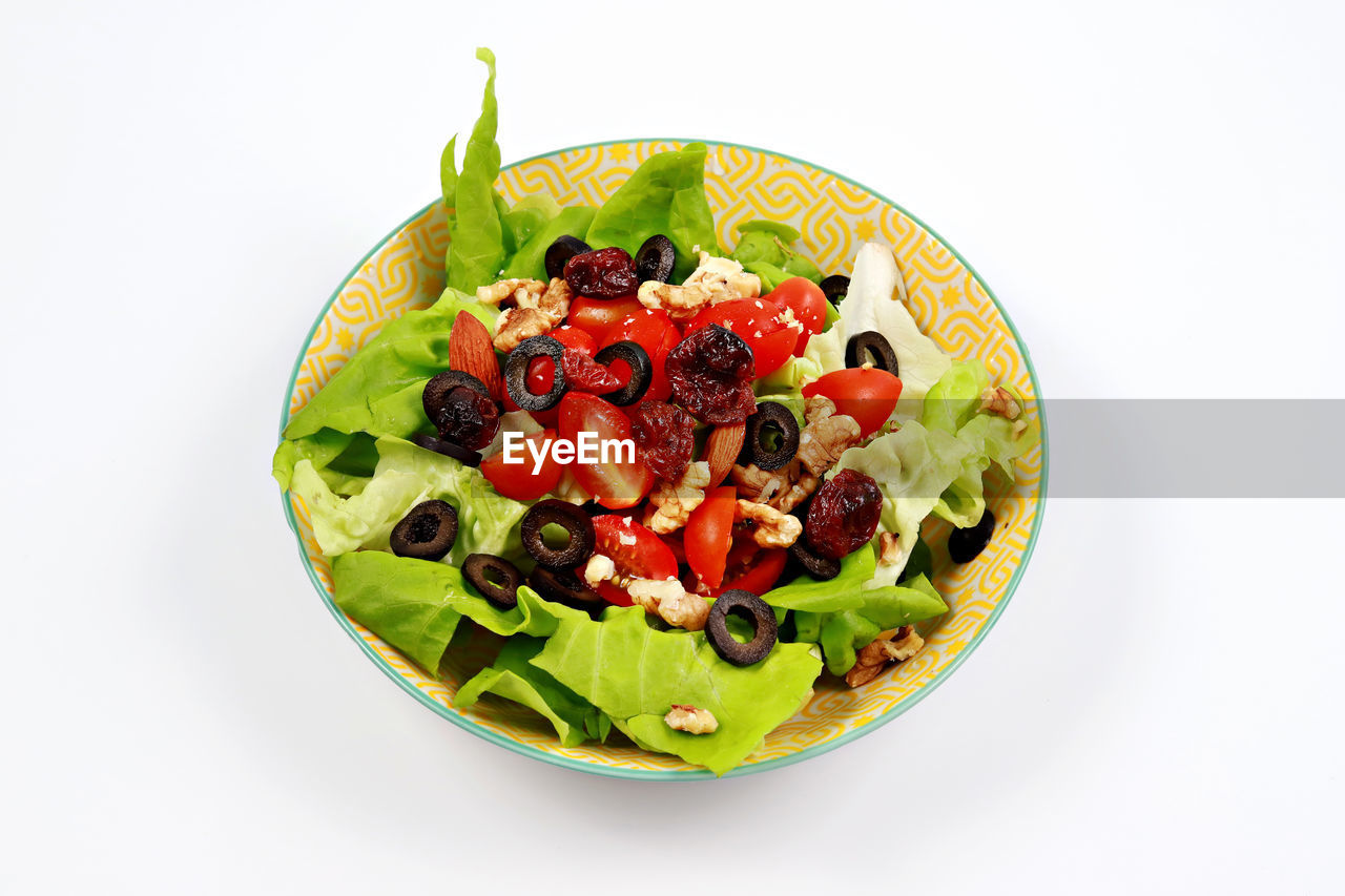 Salad in bowl against white background