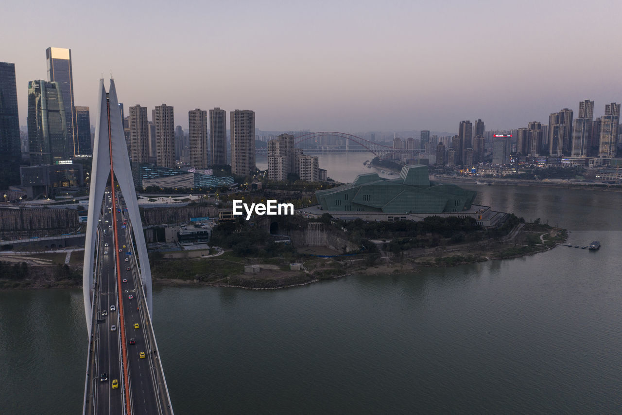 Aerial view of chongqing at sunset with qiansimen bridge and grand theatre on foreground
