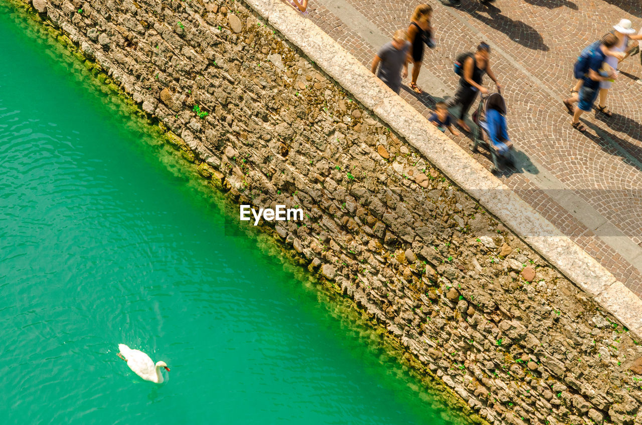 group of people, high angle view, water, architecture, adult, nature, women, people, men, leisure activity, real people, lifestyles, walking, day, city, transportation, full length, built structure, outdoors