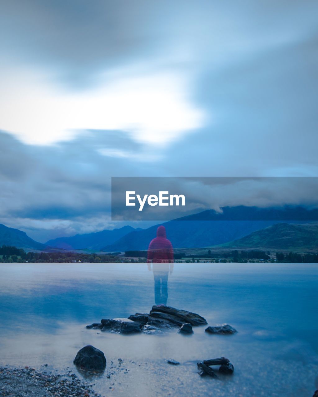 View of calm beach against mountain range