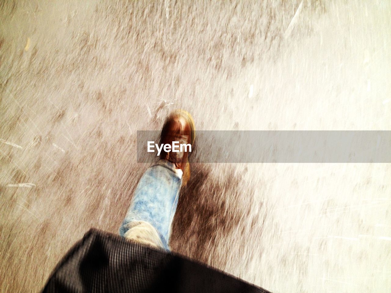 Low section of man walking on street during rainy season