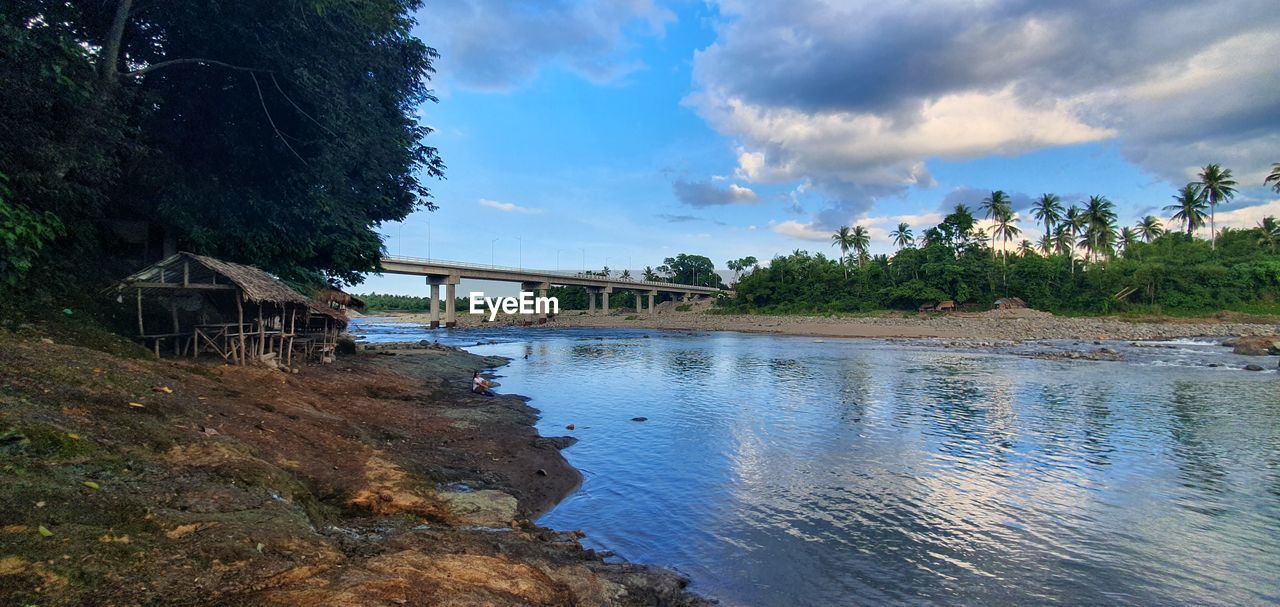 BRIDGE BY RIVER AGAINST SKY