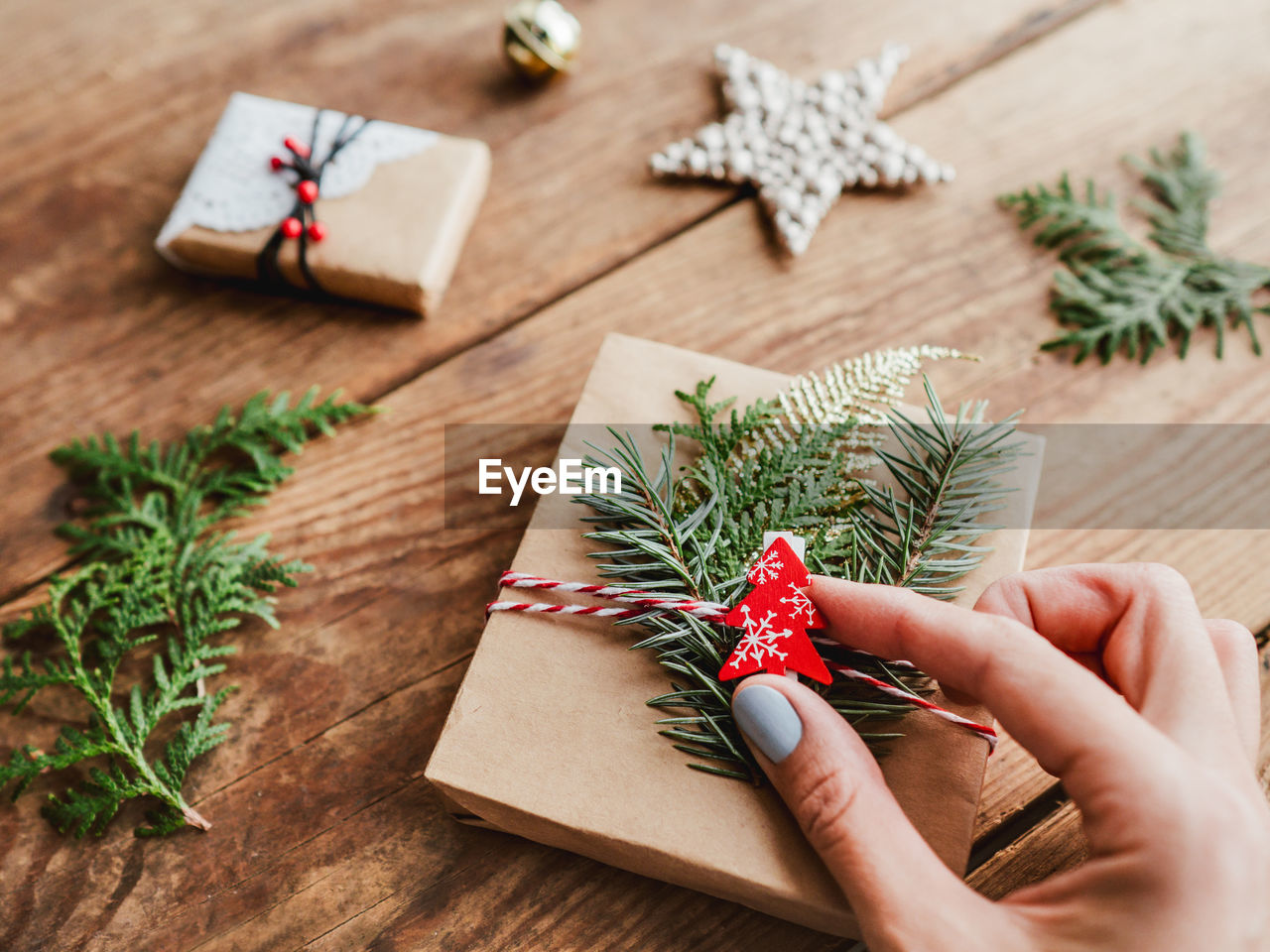 Diy presents wrapped in paper. red decorations in shape of christmas tree, stars. new year gifts.