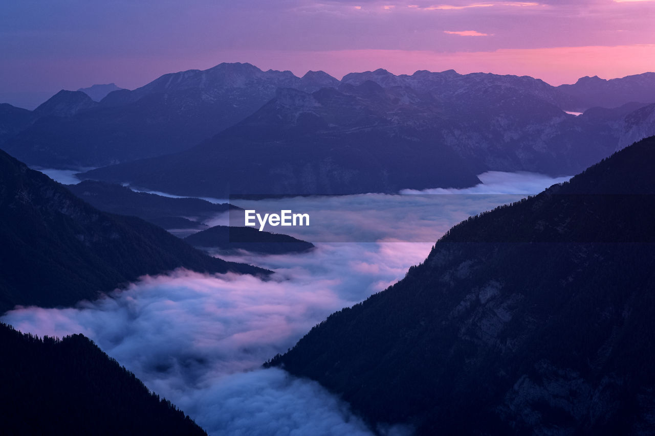 Scenic view of snowcapped mountains against sky at sunrise