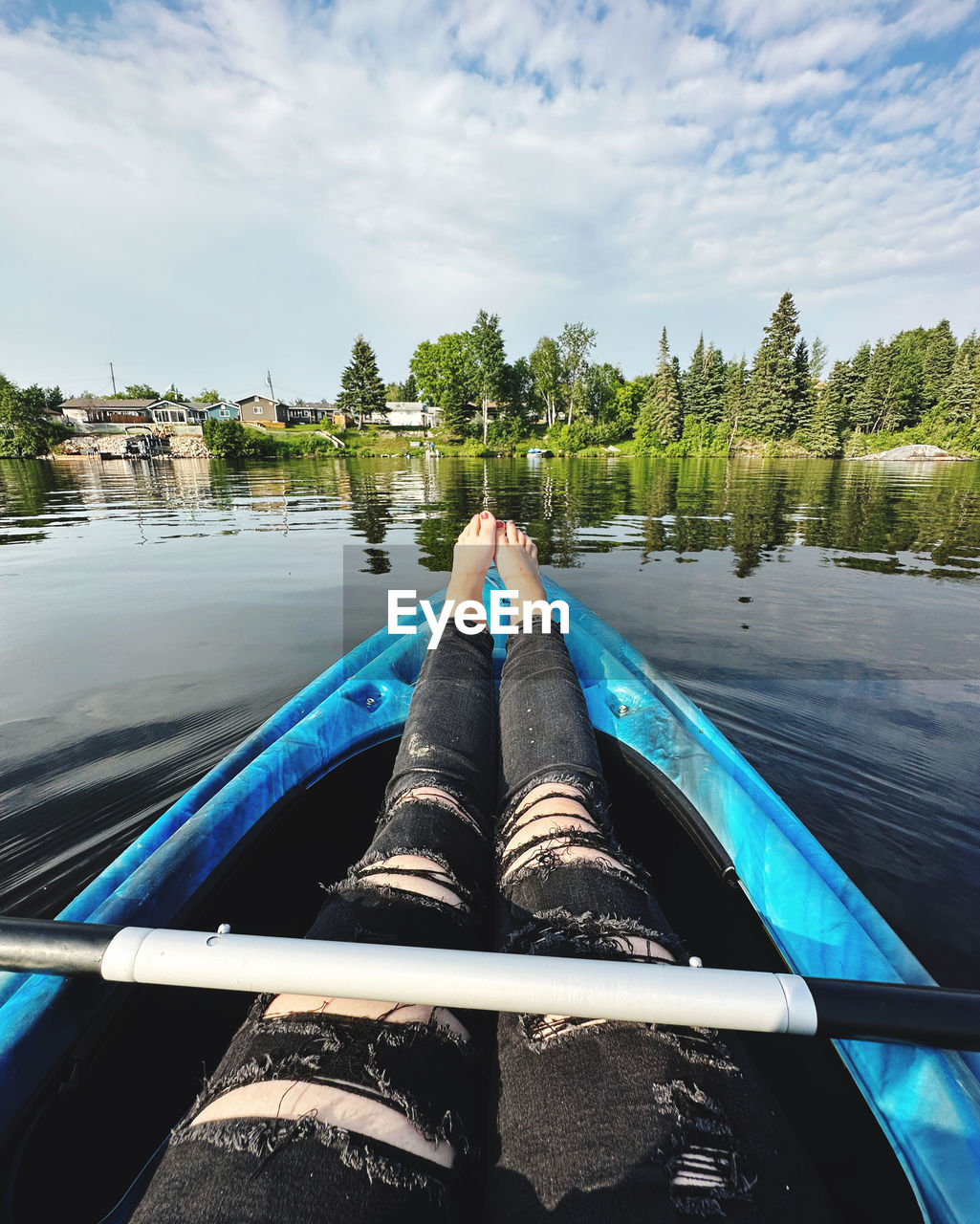 water, boat, vehicle, boating, personal perspective, nature, sky, one person, watercraft, human leg, transportation, nautical vessel, tree, low section, day, cloud, paddle, adult, relaxation, limb, leisure activity, lake, human limb, canoe, lifestyles, plant, outdoors, holiday, trip, vacation, blue, travel, kayak, mode of transportation, tranquility, reflection, sunlight, shoe, scenics - nature, travel destinations, beauty in nature