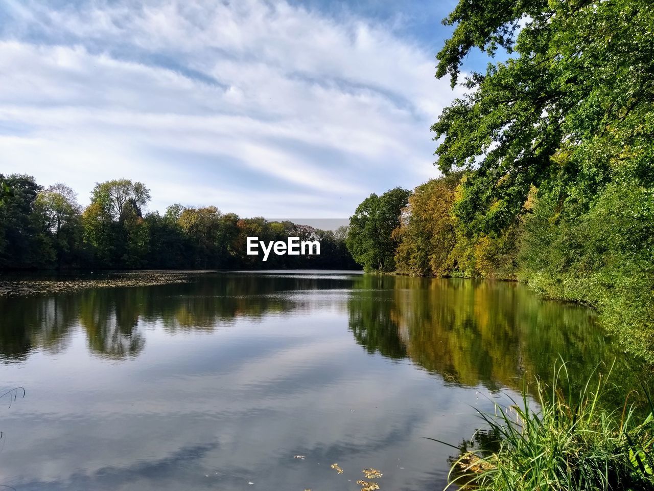 water, tree, plant, reflection, nature, lake, body of water, sky, beauty in nature, tranquility, scenics - nature, cloud, tranquil scene, environment, no people, forest, landscape, non-urban scene, autumn, green, outdoors, leaf, day, land, travel destinations, idyllic, reservoir, grass, summer, waterway, travel, tourism, growth