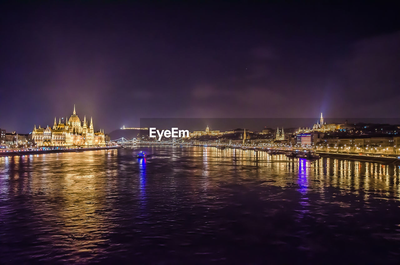 VIEW OF ILLUMINATED CITY AT NIGHT
