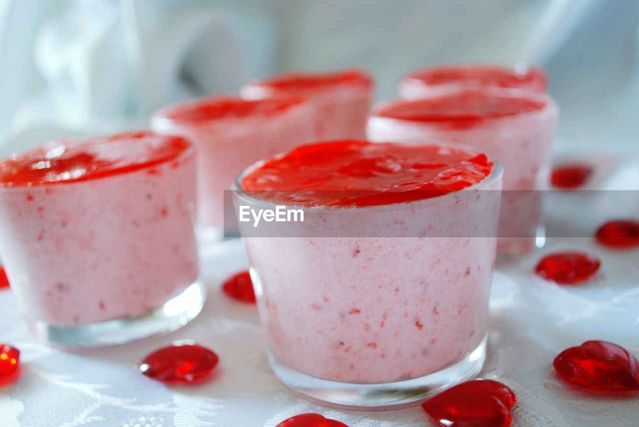 Close-up of strawberry mousse served in glasses on table