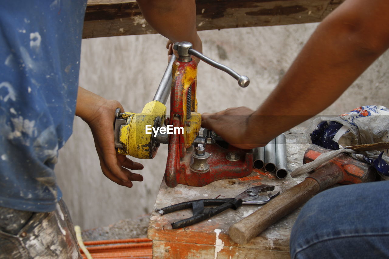 Low angle view of man working on metal