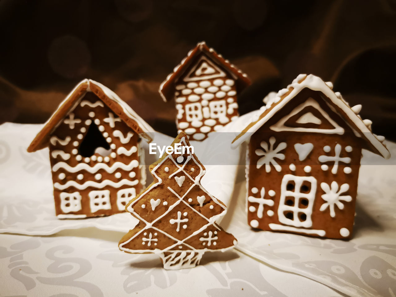 Gingerbread houses and christmas tree decorated with white glaze in new year and christmas patterns
