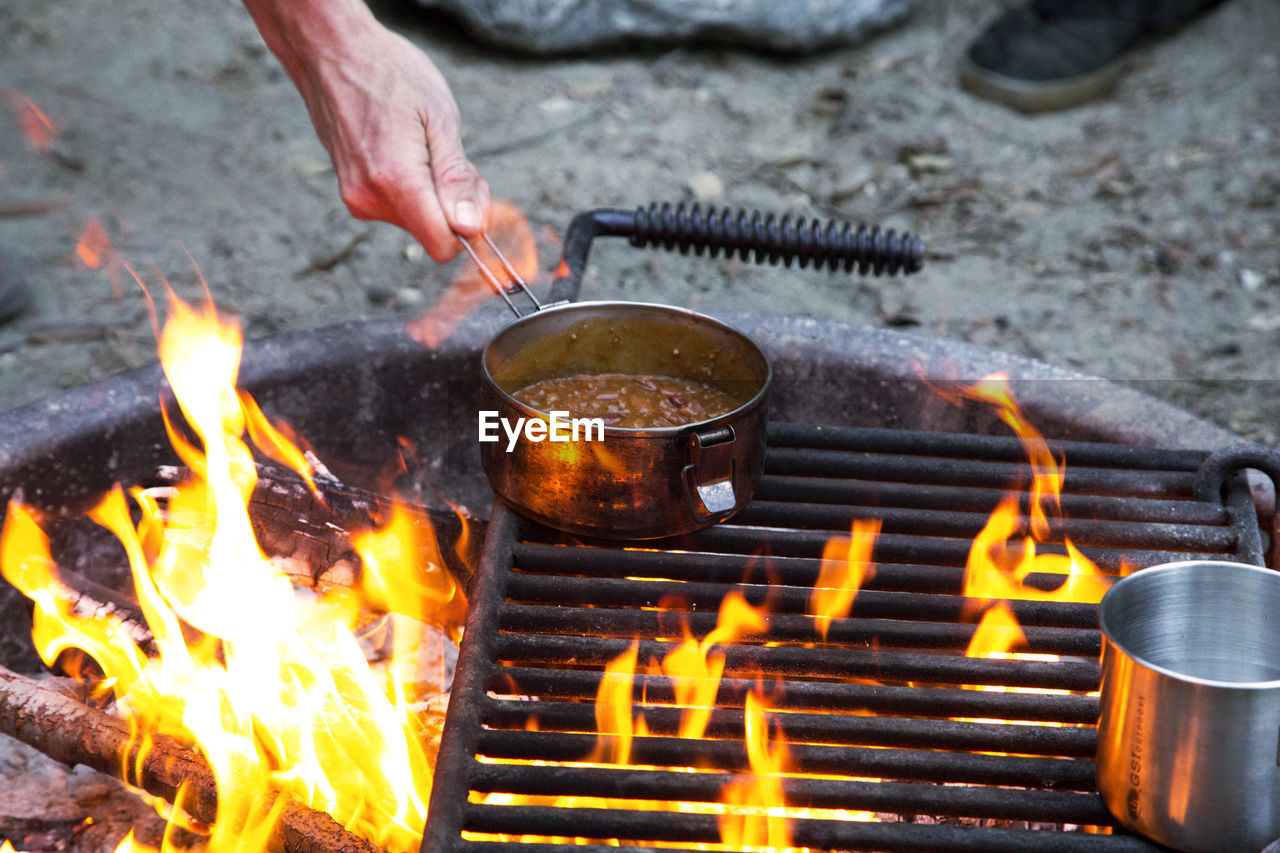 Wood campfire with person cooking