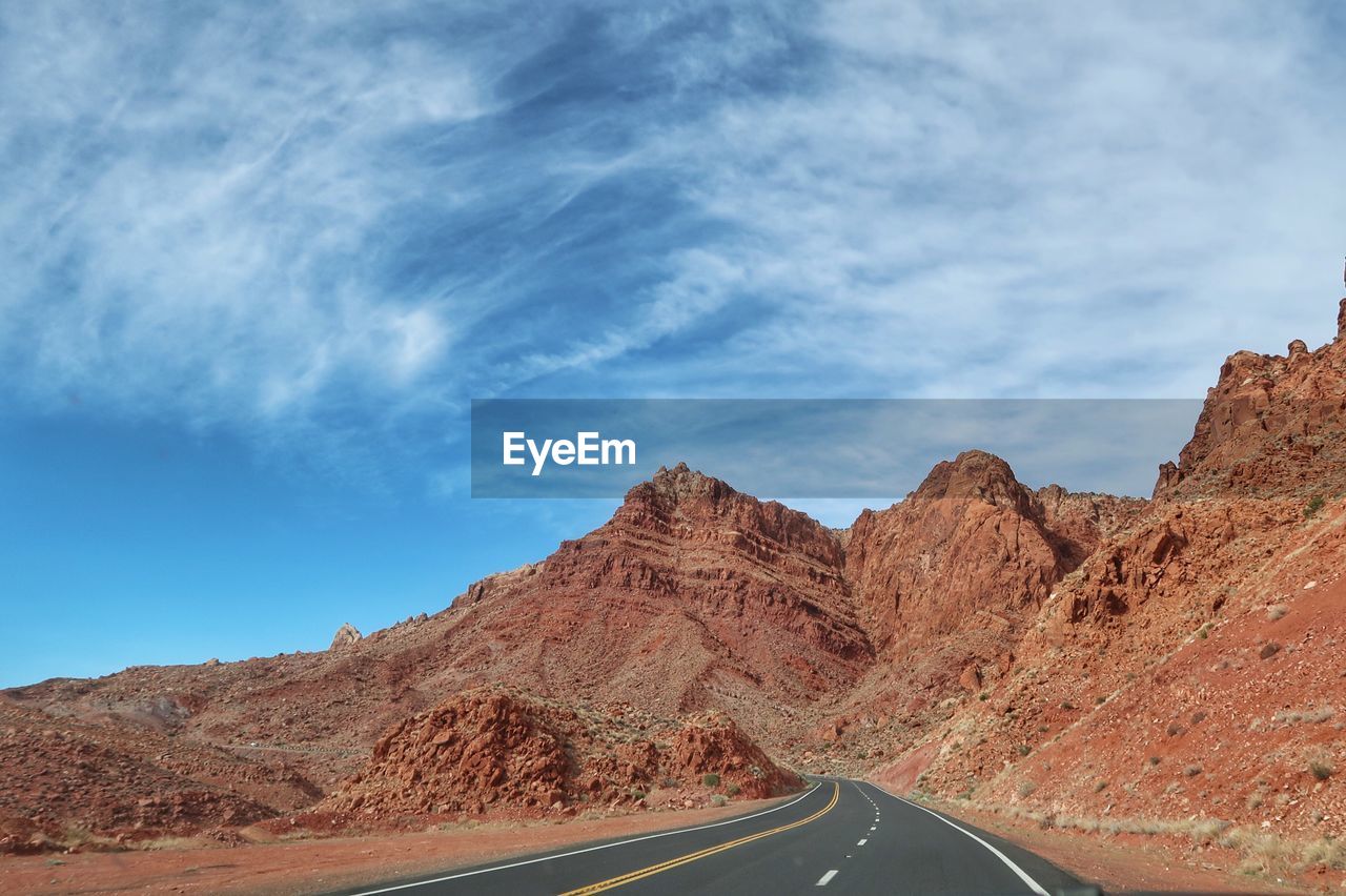 Landscape of road leading to red rocks and hills in arizona