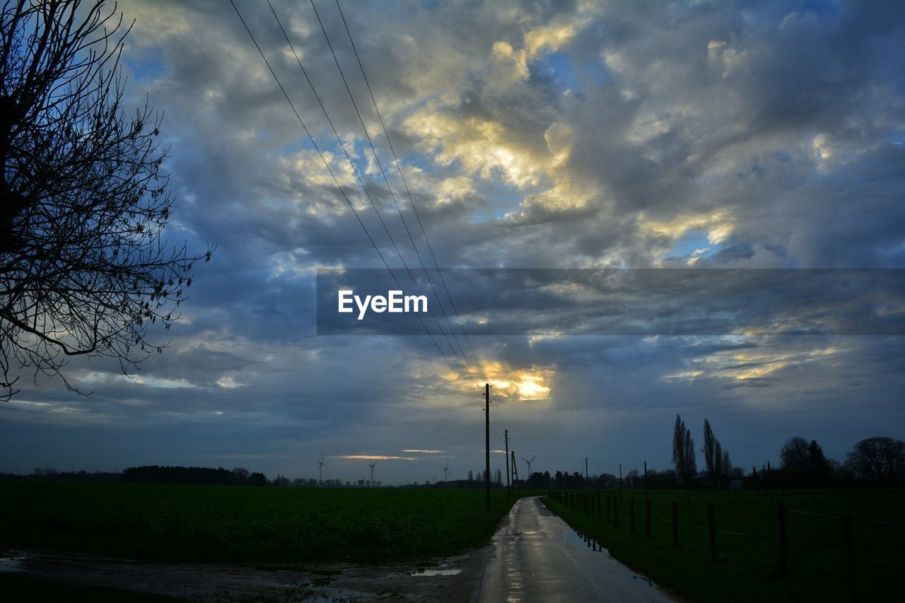 SCENIC VIEW OF ROAD AGAINST DRAMATIC SKY