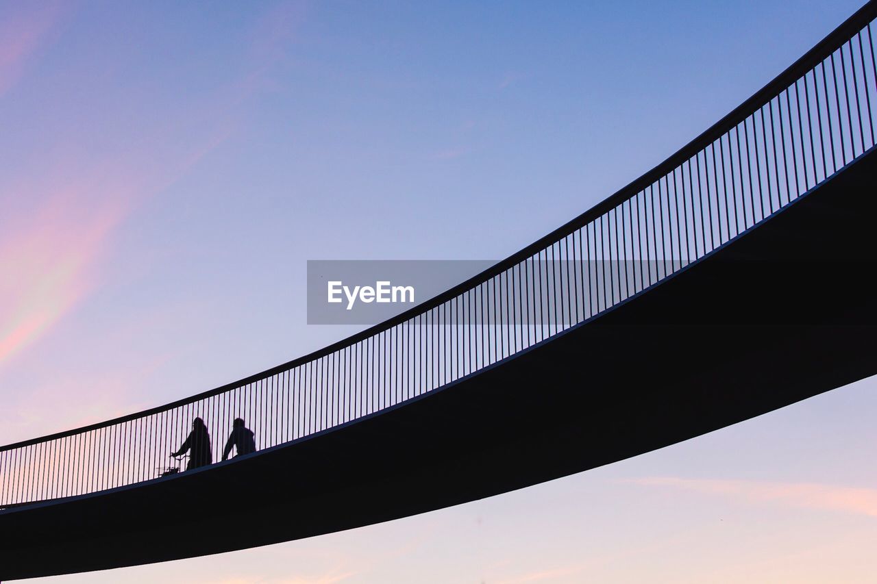 Low angle view of silhouette bridge against sky during sunset