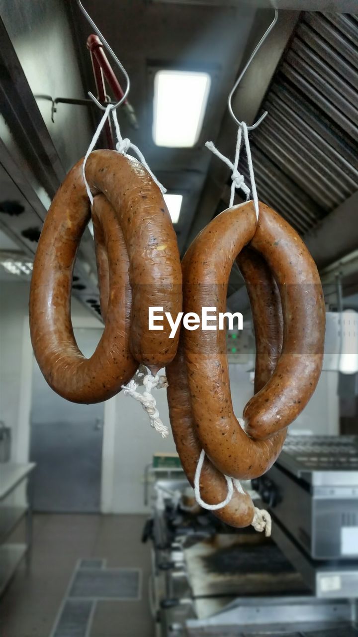 Close-up of sausages hanging in kitchen