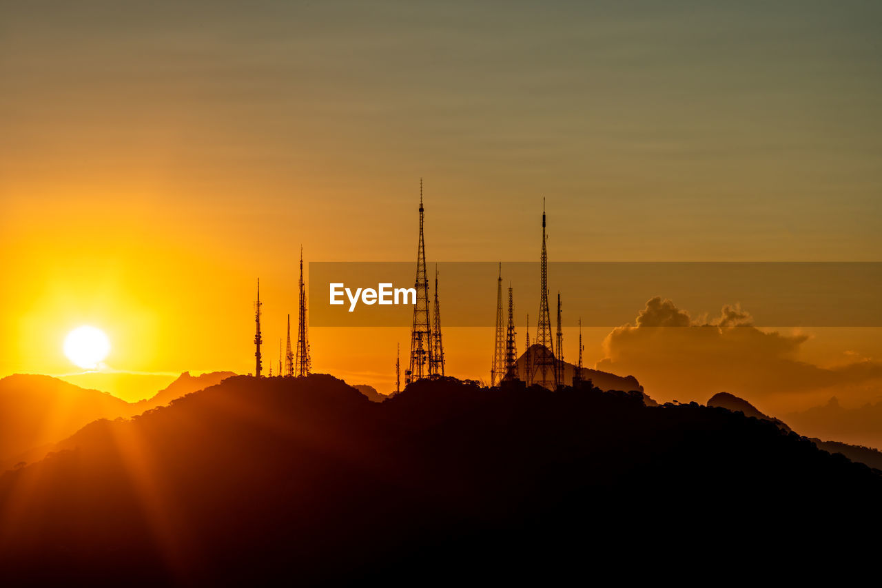 low angle view of silhouette buildings against sky during sunset