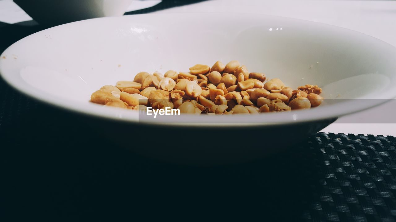 Close-up of peanuts in bowl on table