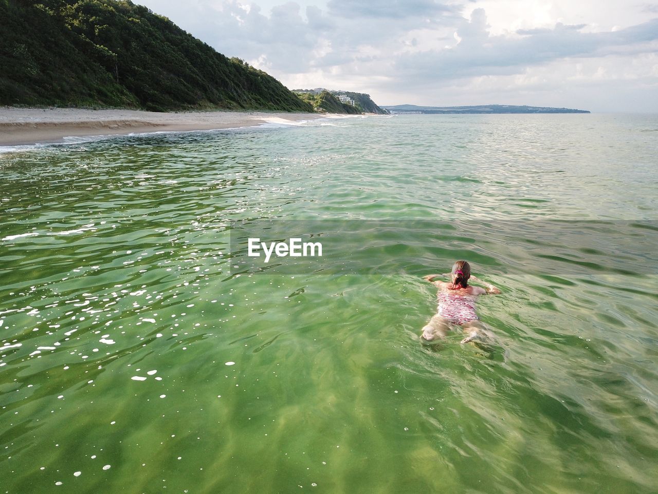 High angle view of woman swimming in sea