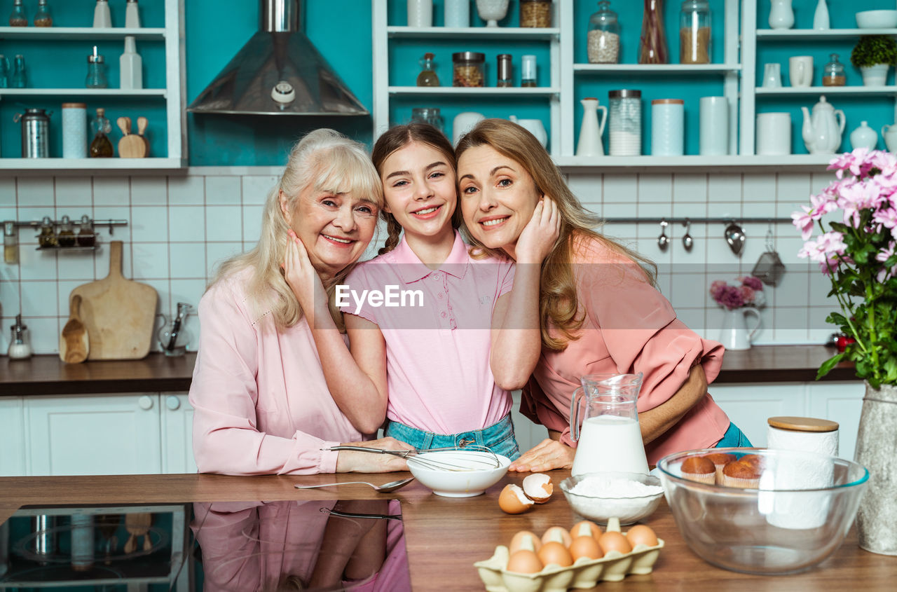Portrait of cheerful family at kitchen