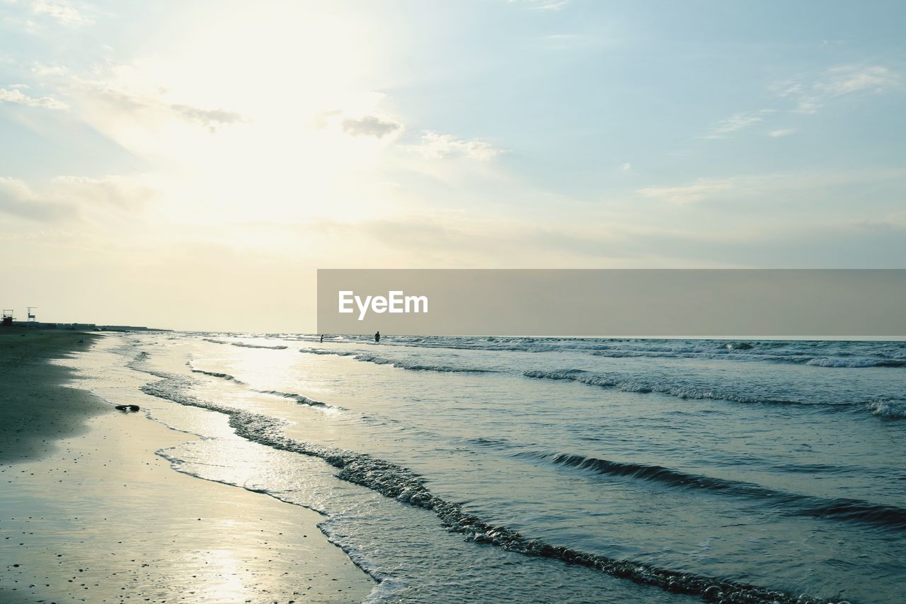 Scenic view of beach against sky during sunset