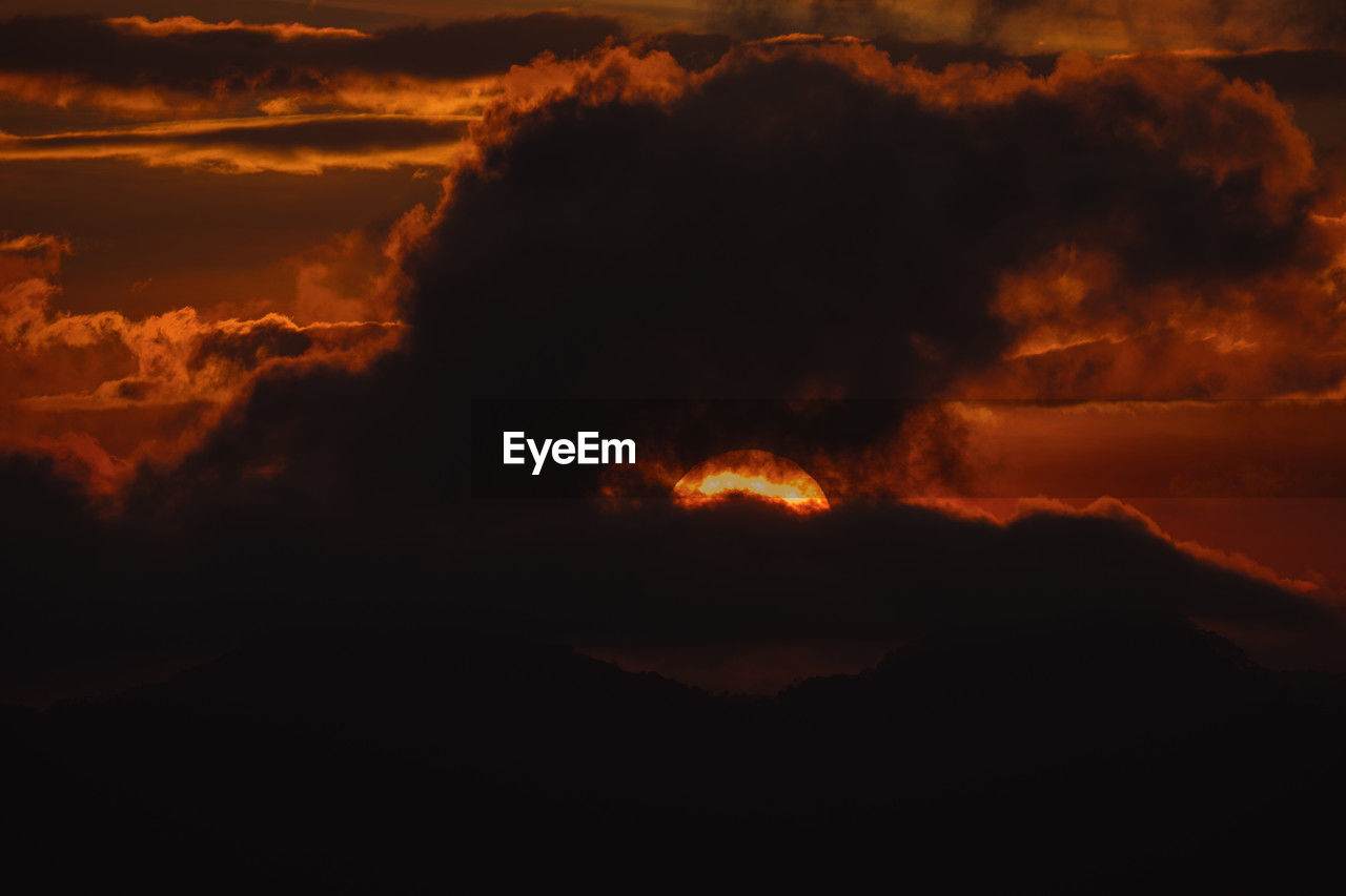 sky, sunset, cloud, beauty in nature, nature, environment, no people, mountain, dawn, orange color, night, afterglow, land, heat, warning sign, geology, lava, scenics - nature, burning, outdoors, volcano, power in nature, landscape, sign, fire, red sky at morning, evening, smoke, erupting, horizon