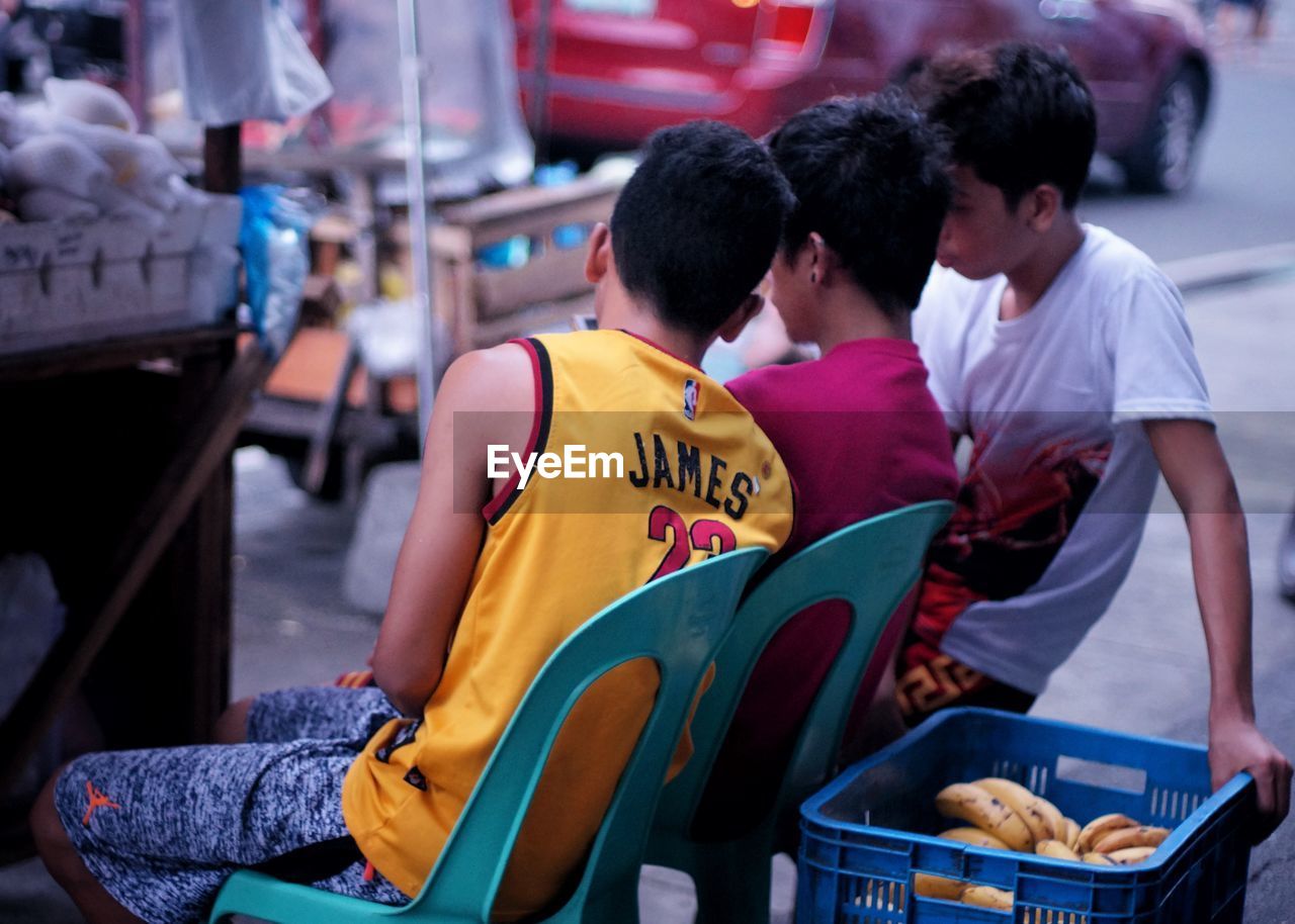 MEN AND MAN SITTING IN THE STADIUM