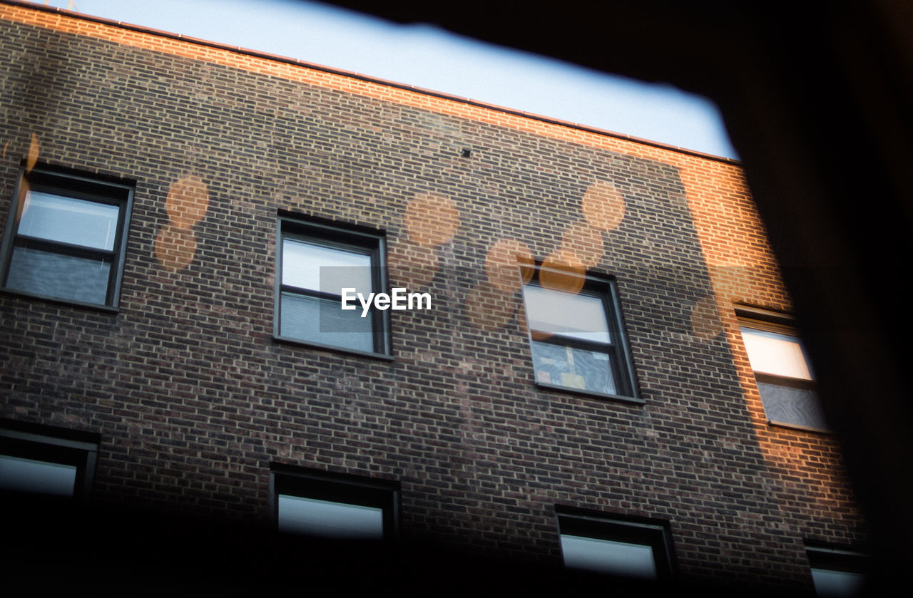 Low angle view of building seen through window