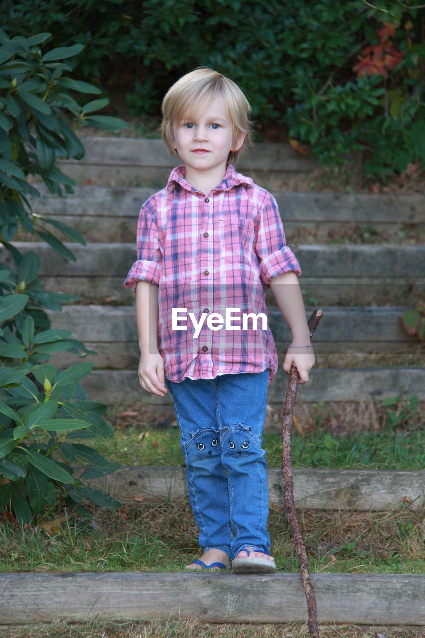 PORTRAIT OF GIRL STANDING OUTDOORS