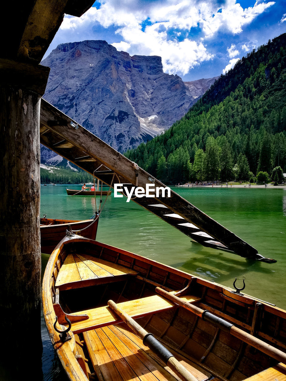 Boat moored in lake against mountains