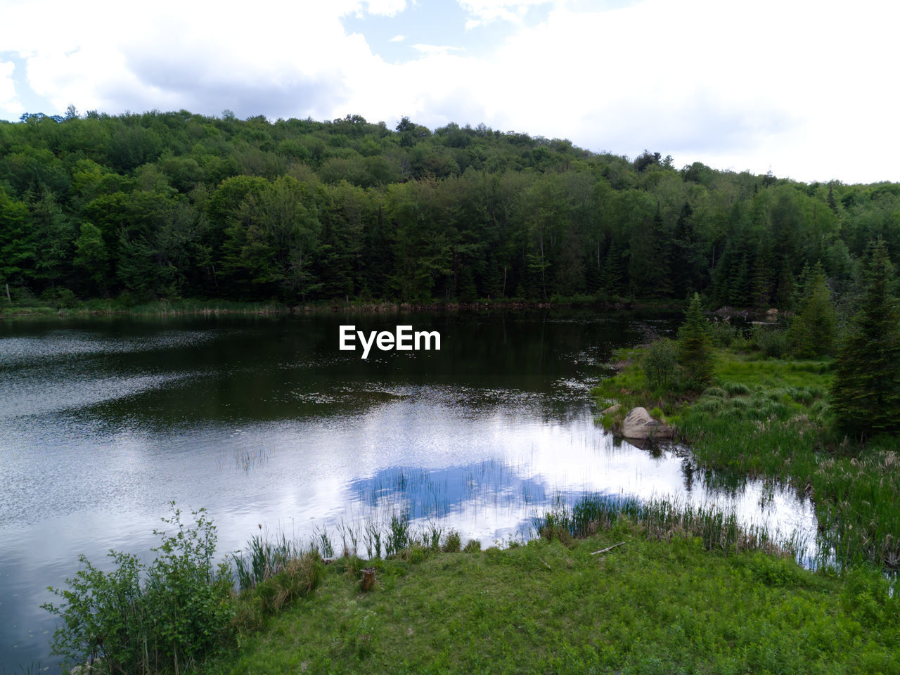 Aerial photos of a lake with calm water on a cloudy summer day in the laurentiens