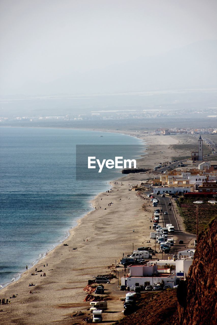 High angle view of sea and buildings against sky