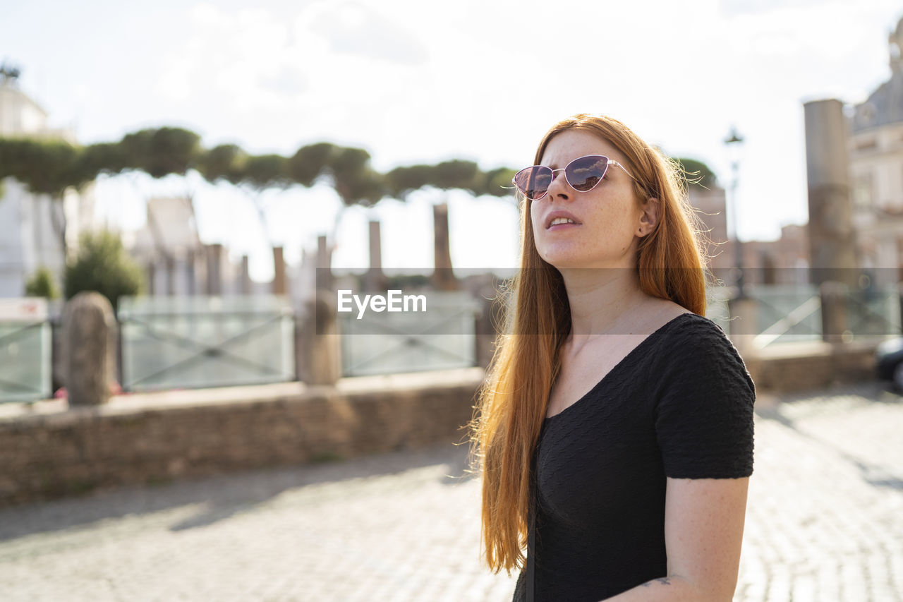 Young woman exploring city during summer holidays