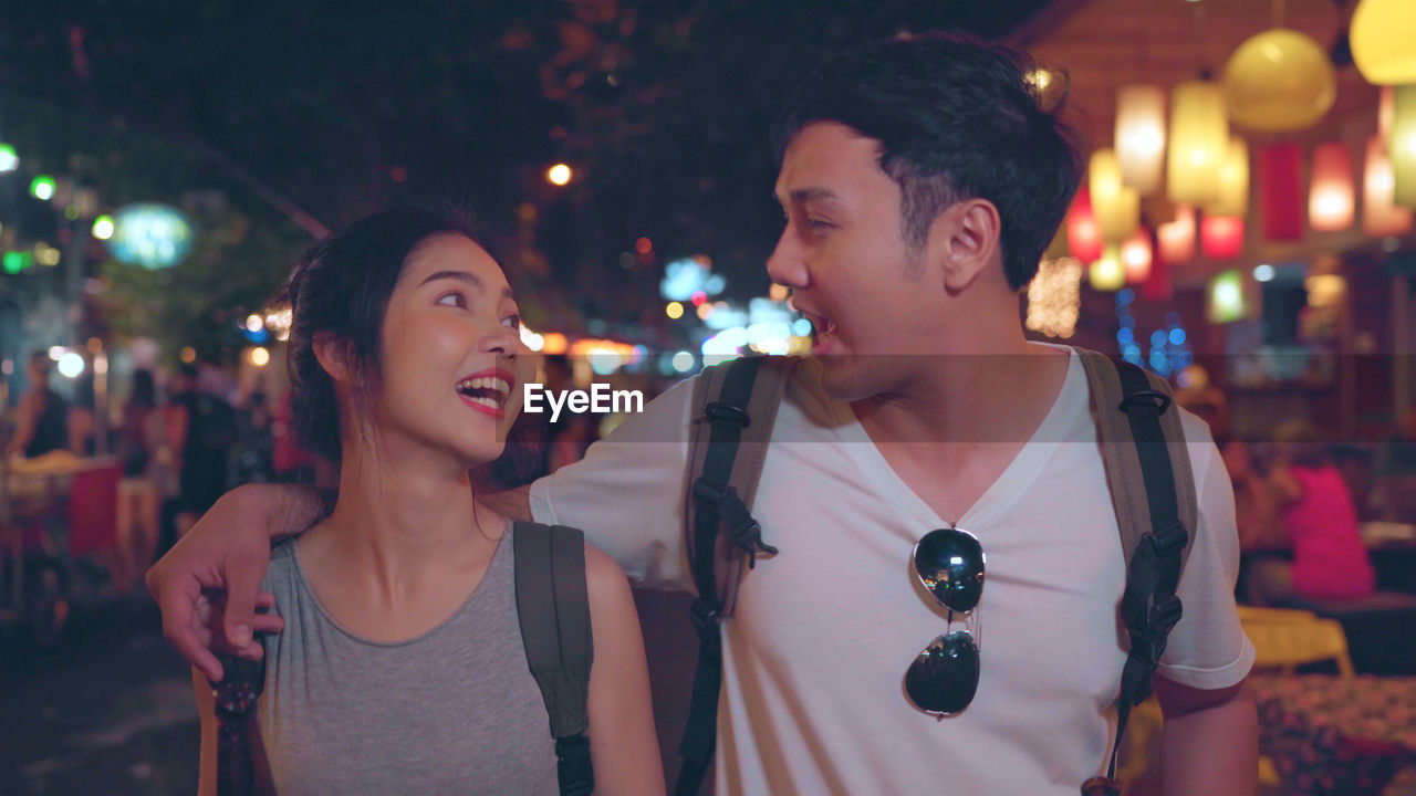 Young couple on street at night