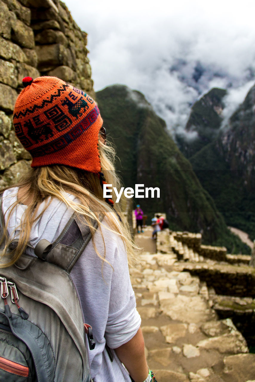 Rear view of woman looking at machu picchu during winter