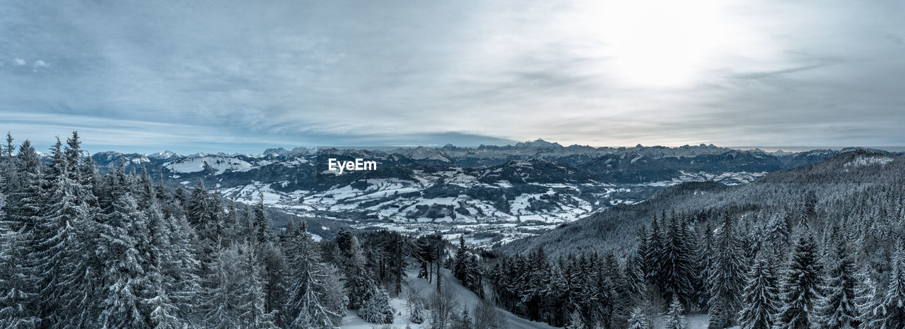 Panoramic view of snow covered landscape against sky